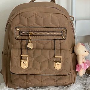Cute backpack with gold accents.